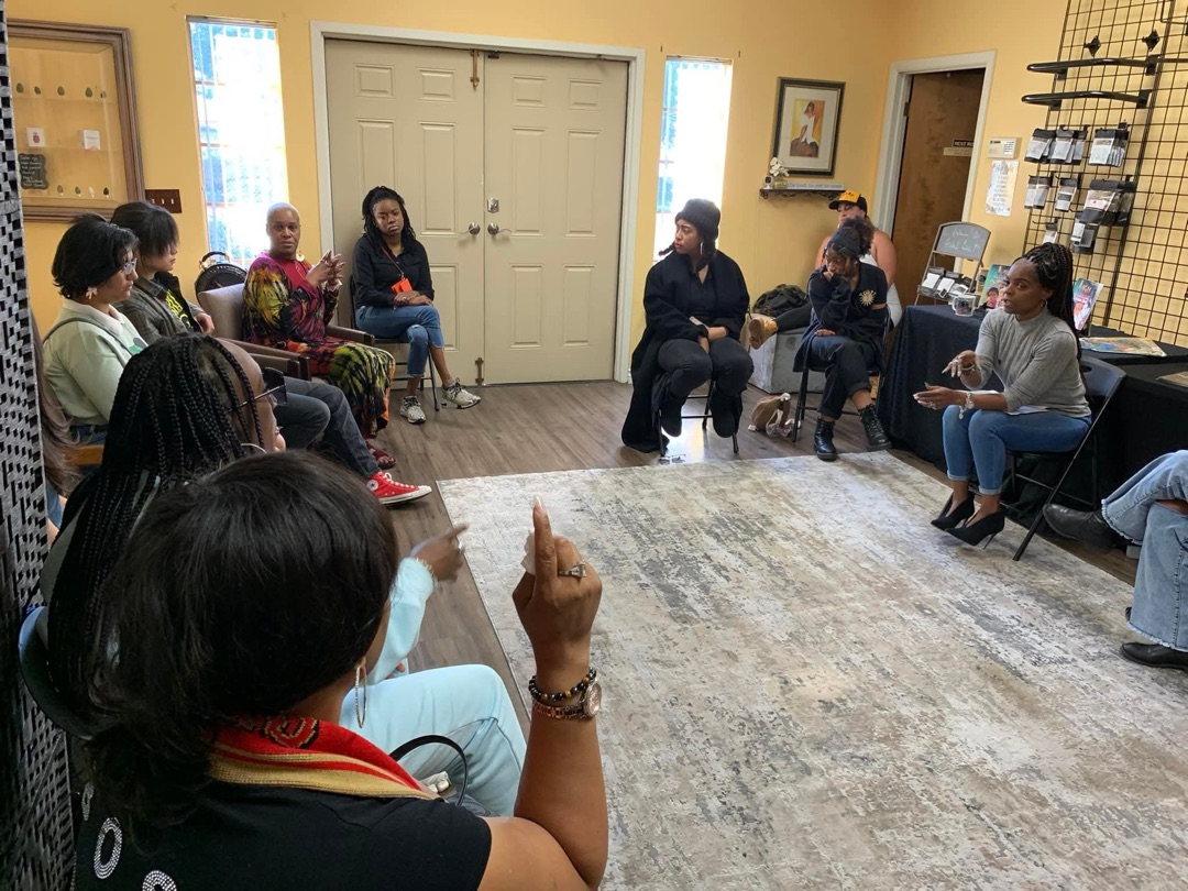 Shannon Martin leading a community discussion circle at GuudSeed Initiative